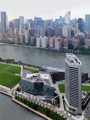 An aerial view of the Cornell Tech campus on Roosevelt Island with the New York City skyline in the background. 